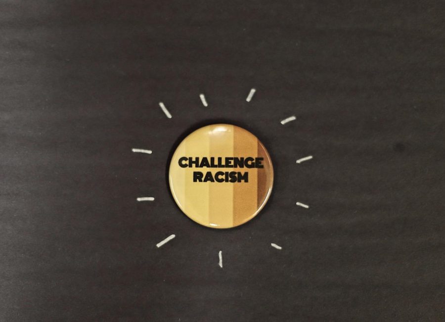 A student-created pin that encourages students to challenge racism.
