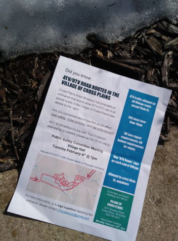 A flier distributed by CP Grassroots lays crumpled on a Cross Plains sidewalk.