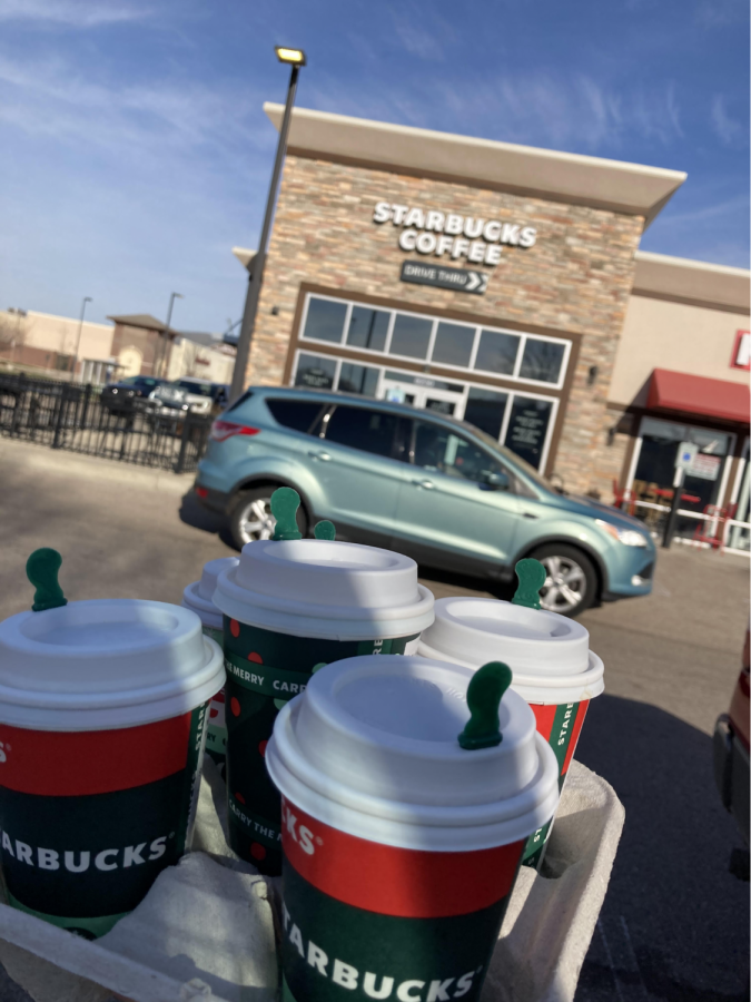 Starbucks’ holiday drinks outside of Starbucks on Greenway Boulevard as lines wrap around the building to go through the drive-thru.