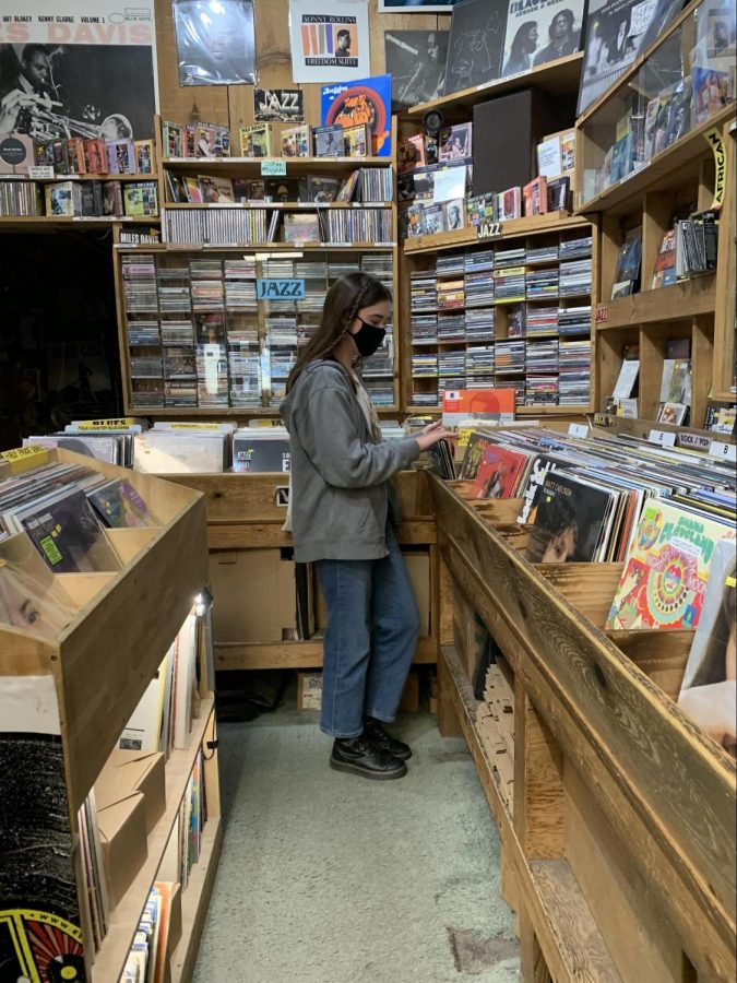 Cardinal Chronicle journalist Addie Johnson shopping for records inside independent Madison record store, B Side.
