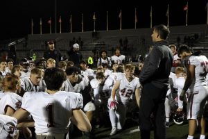 Middleton High School varsity football coach Jason Pertzborn addresses his team at a football game. Pertzborn resigned, citing personal reasons, from his teaching and coaching positions amid an investigation into alleged harassment within the football team.