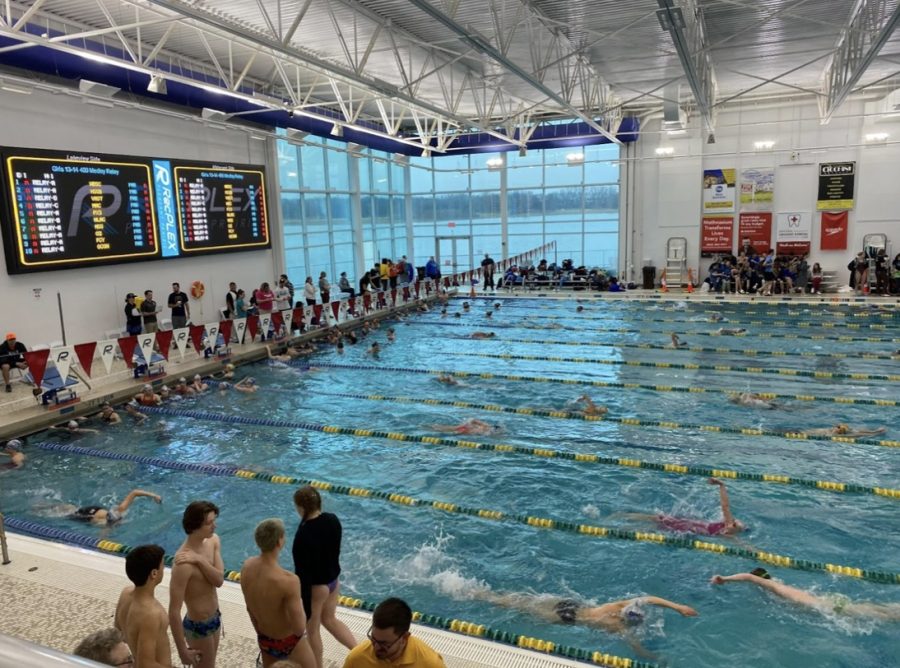 Athletes warm up for the club state championship swim meet. The environment is tense.
