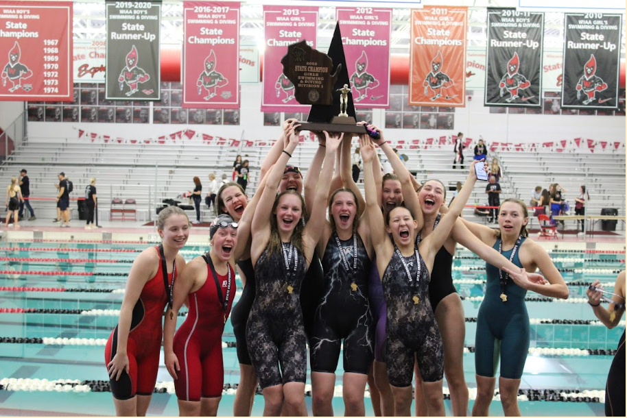 The+team+poses+with+their+first-place+trophy+after+the+400+freestyle+relay.+From+left+to+right%3A+Lily+Mair%2C+Isabell+Frommelt%2C+Brynn+Sundell%2C+Tait+Haag%2C+Sulia+Miller%2C+Clara+Kiehl%2C+Audrey+Alexander%2C+Hannah+Machleidt%2C+Olivia+Davis%2C+Rian+Jost.+