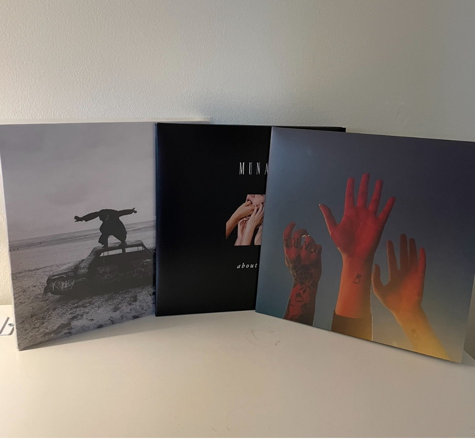 From+left+to+right%3A+Being+Funny+In+a+Foreign+Language+by+The+1975%2C+About+U+by+MUNA%2C+and+the+record+by+boygenius+on+vinyl.+These+three+records+are+perfect+to+listen+to+during+the+winter+season.+