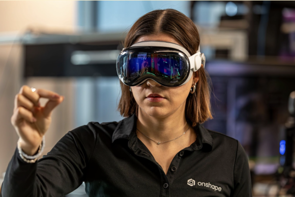 A woman uses the Apple Vision Pro to demonstrate its use in virtual 3D modeling.