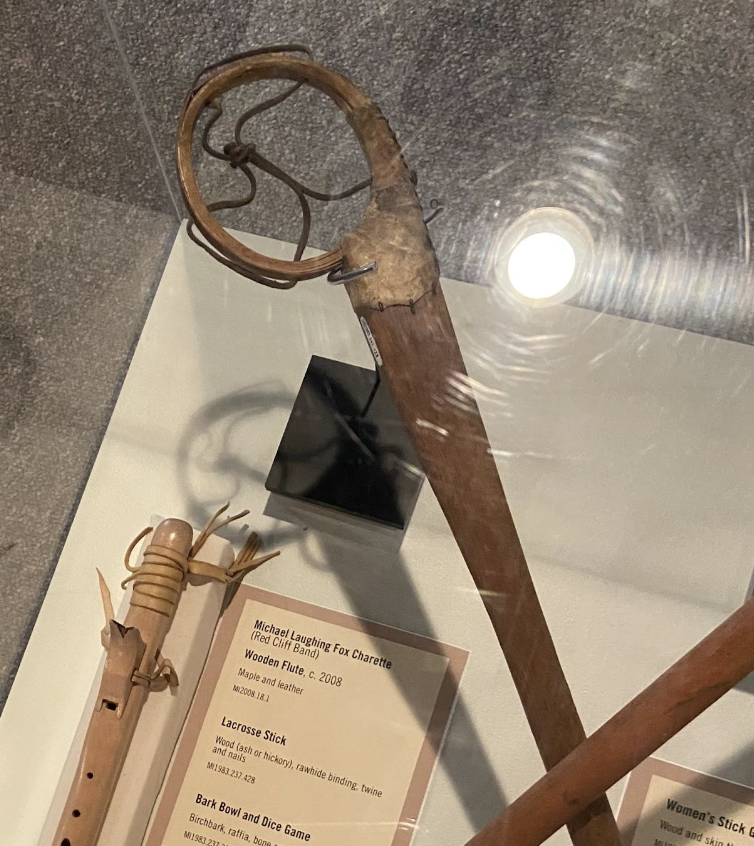 This traditional hickory and leather lacrosse stick, used by Indigenous lacrosse players in Wisconsin, is currently on display at the Madeline Island Museum.