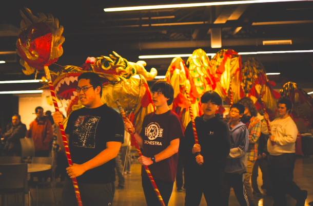 Students at the Lunar New Year Festival at Middleton High School perform with a traditional dragon prop.