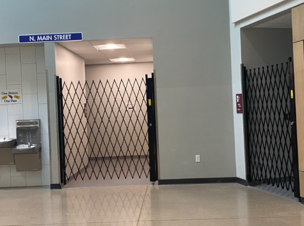 The metal gates installed on the PAC bathrooms prevent students from entering them during the school day. The gates are collapsible and are opened during concerts and performance events.