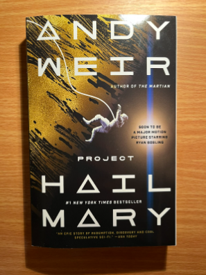 A paperback copy of "Project Hail Mary" by Andy Weir. The film adaptation of this book is coming to theaters soon.